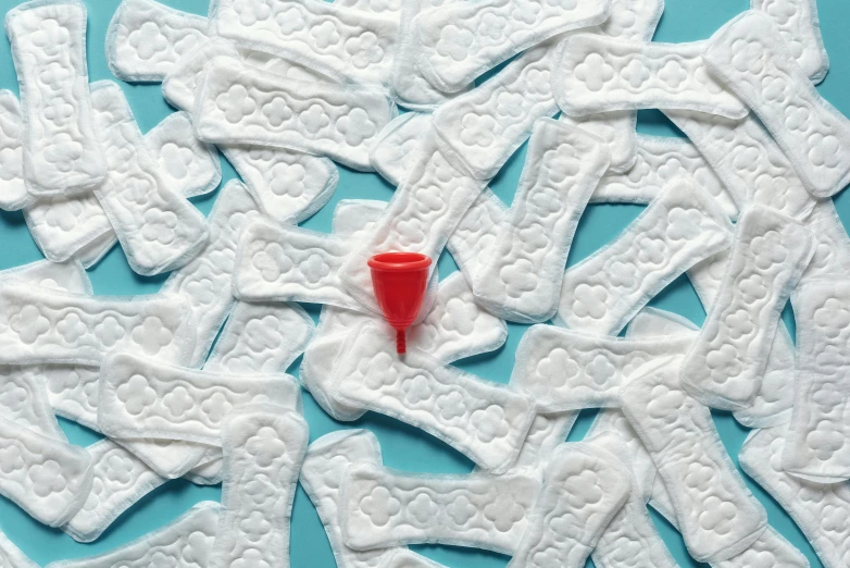 a red cup sitting on top of a pile of white cookies, by Matija Jama, trending on pexels, plasticien, nasal strip, in a laundry mat, contracept, made of lab tissue