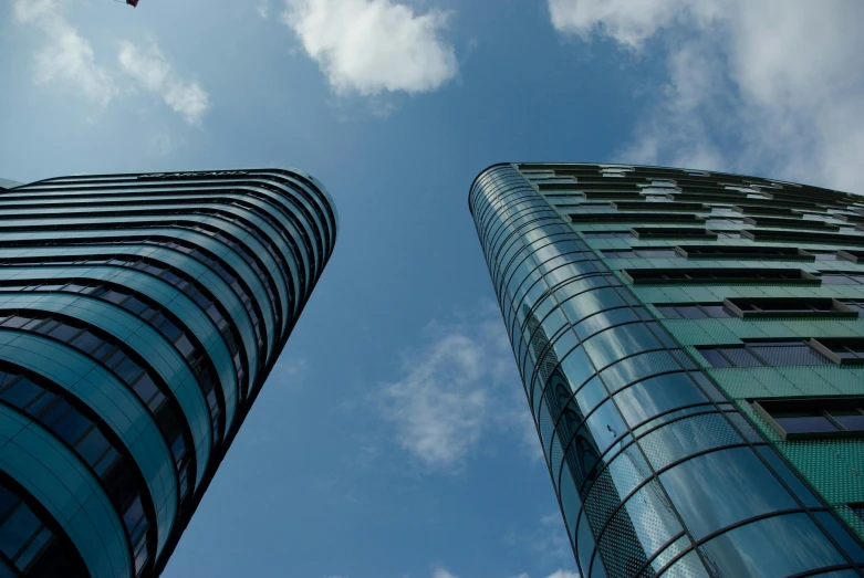 a couple of tall buildings next to each other, by Jan Rustem, pexels contest winner, foster and partners, aquamarine windows, silicon and carbon, high quality upload