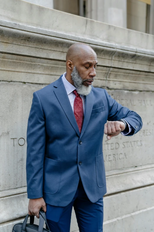 a man in a blue suit and red tie, an album cover, inspired by William H. Mosby, pexels contest winner, renaissance, gray beard, jamel shabazz, concerned, walking down a marble stairwell