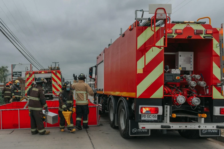 a group of firefighters standing in front of a fire truck, a picture, by Daniel Lieske, pexels contest winner, happening, panoramic shot, avatar image, people at work, english