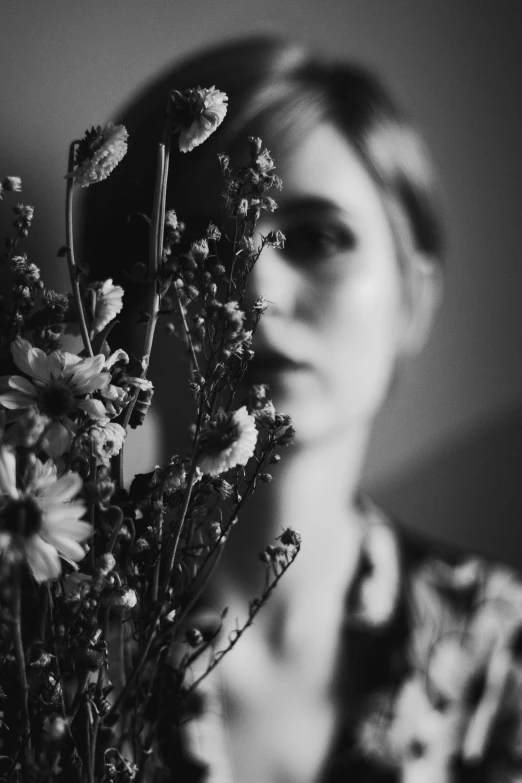 a woman holding a bunch of flowers in front of her face, a black and white photo, unsplash, aestheticism, medium format. soft light, ((portrait)), looking into a mirror, profile pic