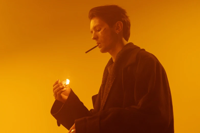 a man with a cigarette in his hand, an album cover, inspired by Jean Malouel, pexels, bauhaus, warm yellow lighting, jung jaehyun, movie still from bladerunner, julian ope