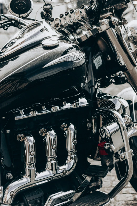 a close up of a motorcycle parked on a street, chrome cathedrals, profile image, black and silver, pipes