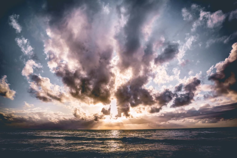 the sun is shining through the clouds over the ocean, pexels contest winner, multiple stories, pink and grey clouds, uploaded, apocalyptic tumultuous sea