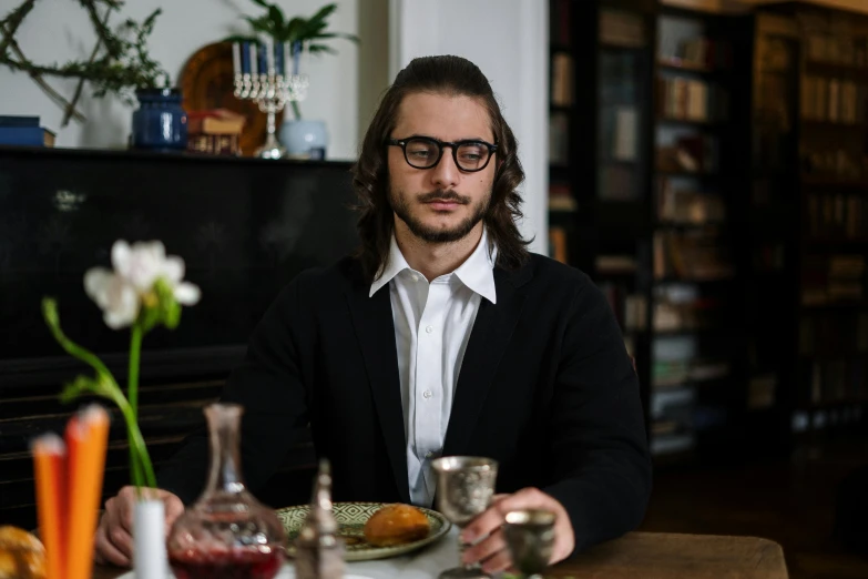 a man sitting at a table with a plate of food, a portrait, by Meredith Dillman, pexels contest winner, renaissance, jewish young man with glasses, tuomas korpi and wlop, press shot, sydney hanson