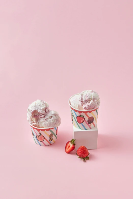 two cups of ice cream with strawberries on a pink background, inspired by Pearl Frush, 3 / 4 wide shot, striped, foil, product image