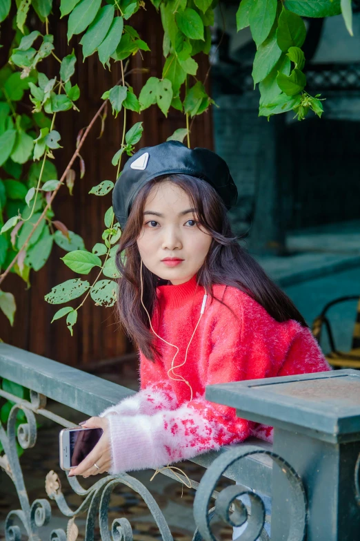 a girl in a red sweater leaning on a fence, a picture, inspired by Kim Jeong-hui, trending on pexels, realism, berets, young cute wan asian face, 🌺 cgsociety, sitting on a bench