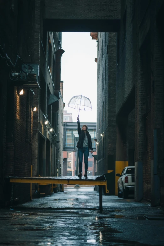 a person standing in the middle of an alleyway, umbrella, floating in mid - air, standing on a bridge, waving