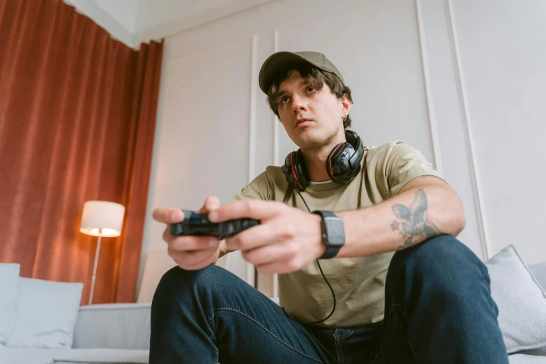 a man sitting on a couch holding a video game controller, by Adam Marczyński, pexels, hyperrealism, sitting at a control center, joe keery, serious, sitting in a lounge