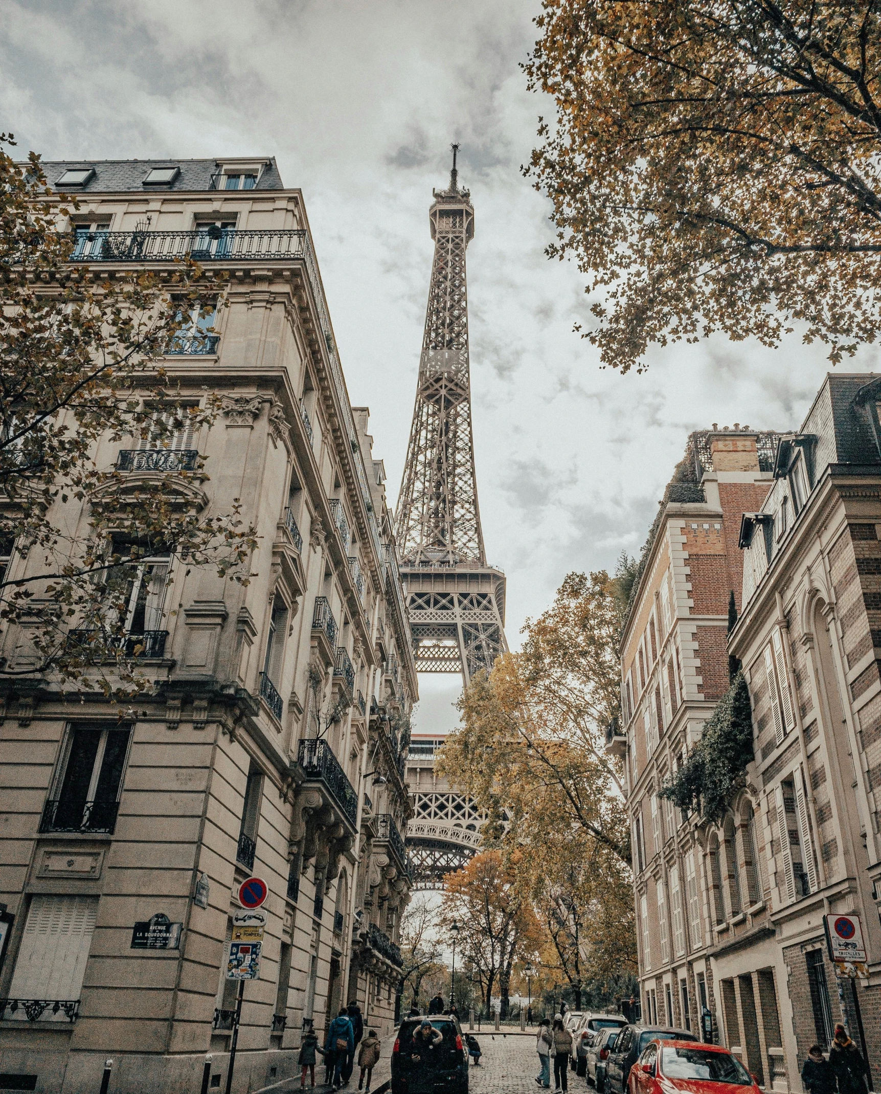 the eiffel tower towering over the city of paris, unsplash contest winner, paris school, walking down a street, brown, 2 0 2 2 photo, fall season