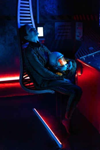 a man sitting on a chair in front of a computer, cyberpunk art, inspired by Beeple, unsplash contest winner, retrofuturism, sitting sad in spaceship, a 1980s goth nightclub in soho, clothed in space suit, cyberpunk 2 0 y. o model girl