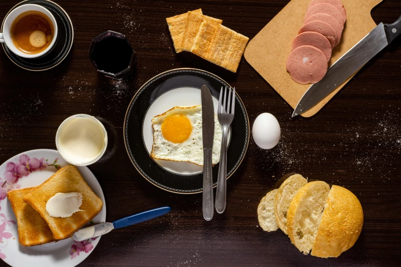 a wooden table topped with plates of food, a still life, by Sven Erixson, pexels contest winner, dau-al-set, an egg, toast, pastelle, full product shot