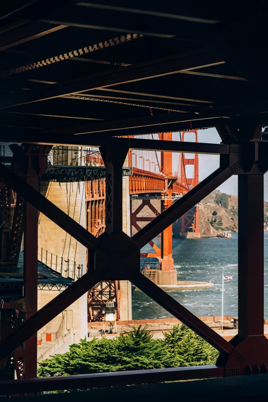 a view of the golden gate bridge from under a bridge, inspired by Thomas Struth, pexels contest winner, high view, industrial architecture, telephoto shot, slide show