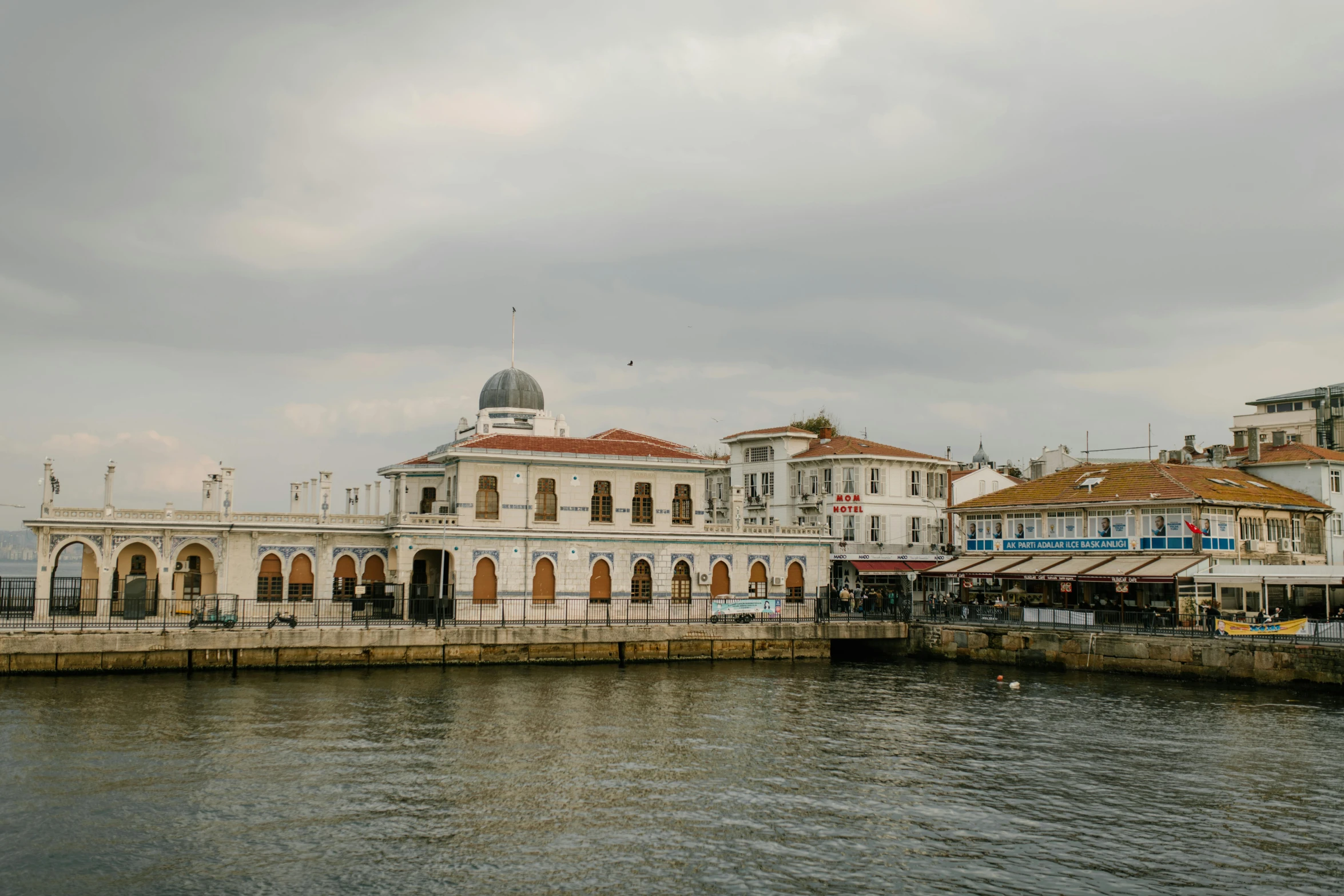 a large white building sitting next to a body of water, by Michalis Oikonomou, pexels contest winner, market, byzantine, front side, grayish