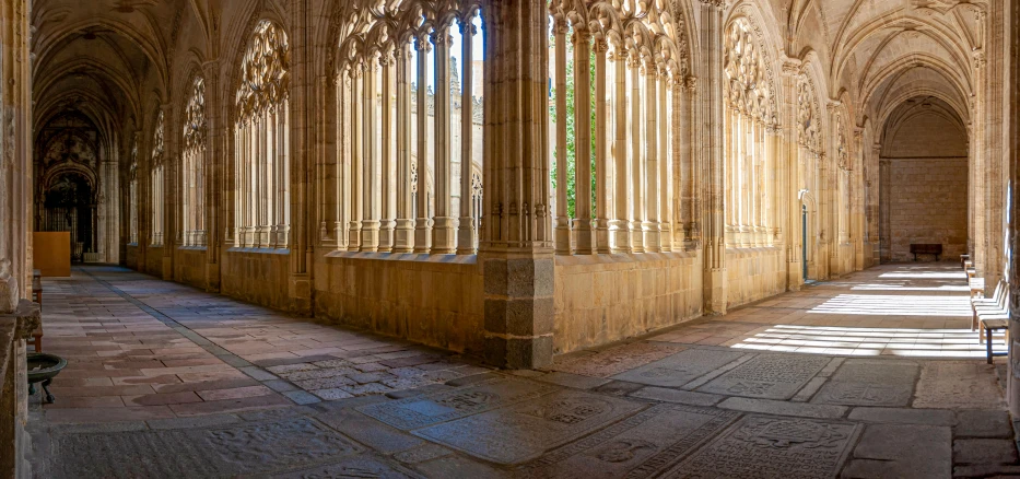 the sun shines through the windows of a cathedral, inspired by Luis Paret y Alcazar, pexels contest winner, romanesque, panoramic, colonnade, estefania villegas burgos, ground-level view