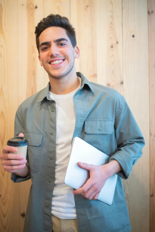 a man holding a cup of coffee and a book, lean man with light tan skin, holding a clipboard, at college, promotional image