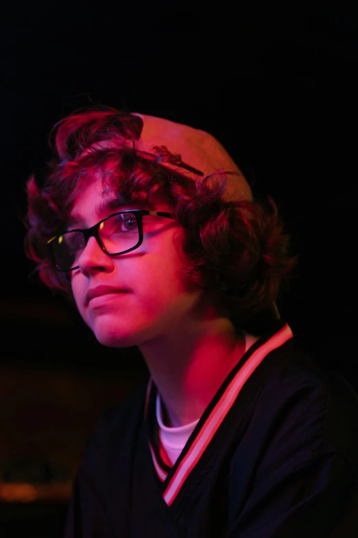 a young man wearing glasses and a baseball cap, an album cover, pexels, rebecca sugar, ariel perez, looking off into the distance, nigth