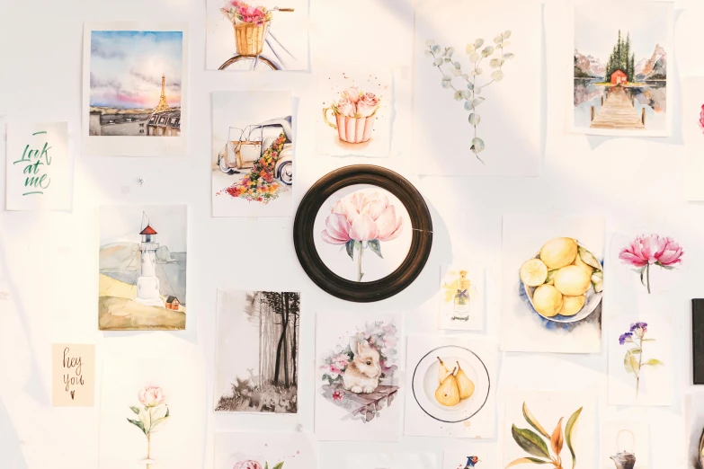 a wall that has a bunch of pictures on it, a watercolor painting, trending on pexels, delicate garden on paper, round format, flatlay, hd artwork