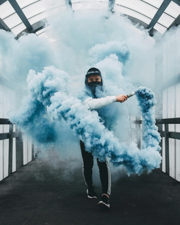 a man standing in a tunnel covered in blue smoke, a colorized photo, pexels contest winner, trending on r/streetwear, smoke coming out of her mouth, smoke grenade, trending on pinterest，maximalist