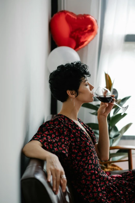 a woman sitting on a couch holding a glass of wine, pexels contest winner, renaissance, making out, sarah andersen, profile image, casually dressed