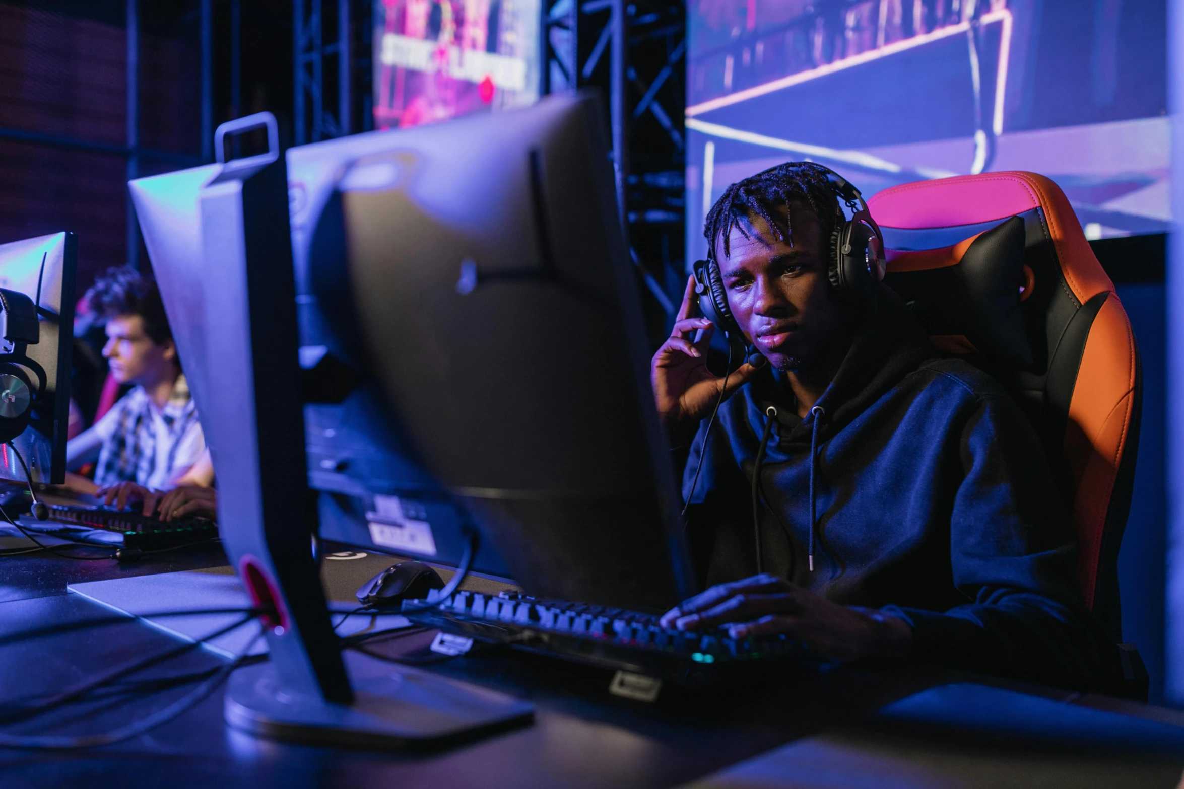 a man sitting in front of a computer on a desk, hurufiyya, esports, lil uzi vert, profile image, a busy arcade