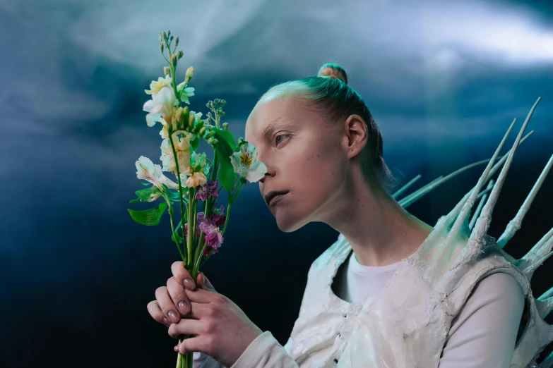 a woman in a white dress holding a bunch of flowers, inspired by Ignacy Witkiewicz, greta thunberg as gollum, production photo, beth cavener, artem chebokha