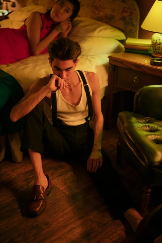 a couple of people sitting on top of a bed, inspired by Nan Goldin, trending on pexels, bauhaus, emma watson modeling for gucci, suspenders, male model, in a dark dusty parlor