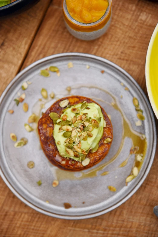 a close up of a plate of food on a table, by Helen Stevenson, hurufiyya, pumpkin, full of greenish liquid, thumbnail, donut