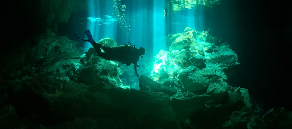 a person on a scuba board in a cave, pexels contest winner, mexico city, coral reef, promo image, back lit