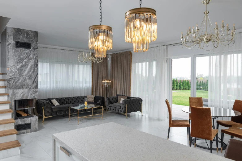 a living room filled with furniture and a chandelier, by Adam Marczyński, light and space, golden dapple lighting, polish mansion kitchen, chesterfield, beaded curtains