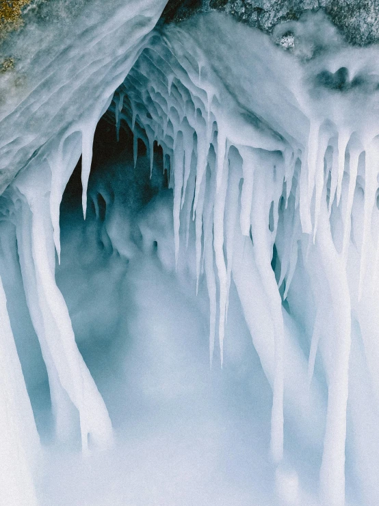 an ice cave with icicles hanging from it's sides, pexels contest winner, thumbnail, mammoth, white, cold hues