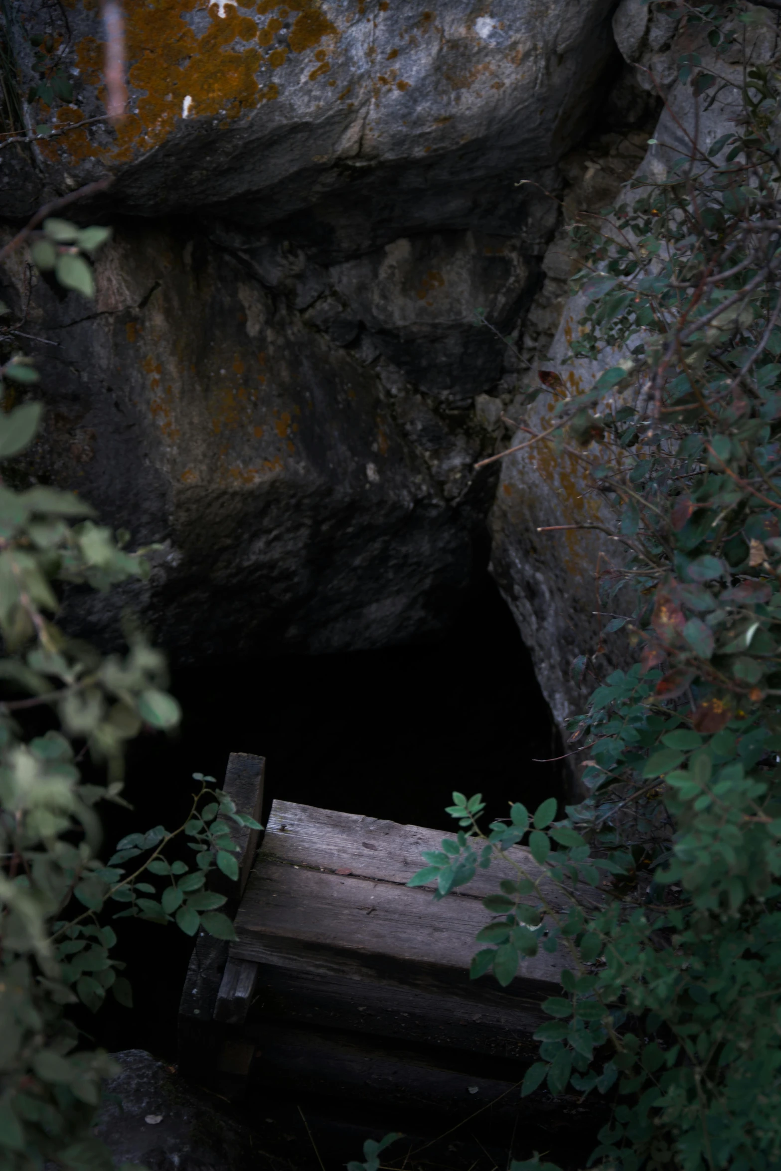 a wooden bench sitting in the middle of a cave, by Elsa Bleda, les nabis, tar pit, a high angle shot, black, 2 5 6 x 2 5 6 pixels