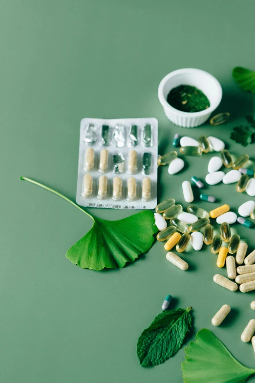 a variety of pills and capsules on a green surface, a picture, trending on pexels, renaissance, made of leaves, white, thumbnail, fan favorite