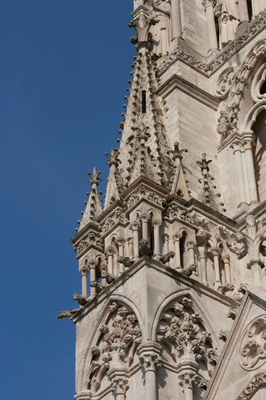 a clock that is on the side of a building, romanesque, majestic spires, buttresses, close - up photograph, square