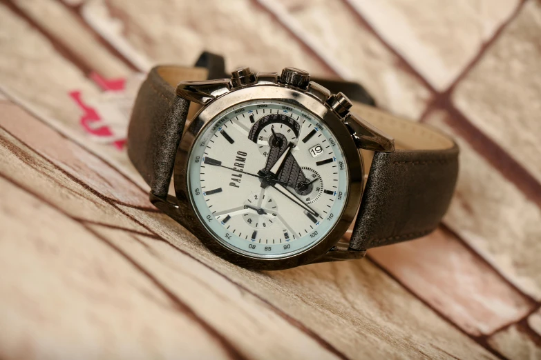 a close up of a wrist watch on a table, fluxus, in style of billelis, mint, medium, fossil