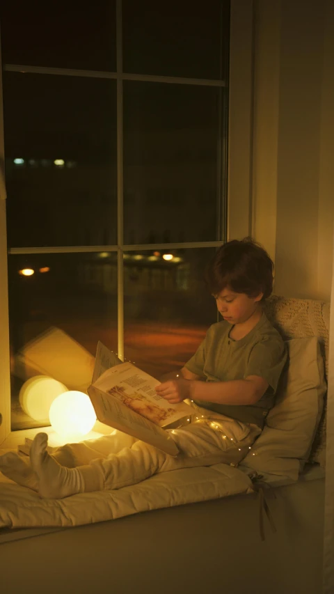 a little boy that is sitting in a window sill, inspired by Joseph Wright of Derby, pexels, light and space, lamp ( ( ( armchair ) ) ) ), studyng in bedroom, fairy lights, plasma globe