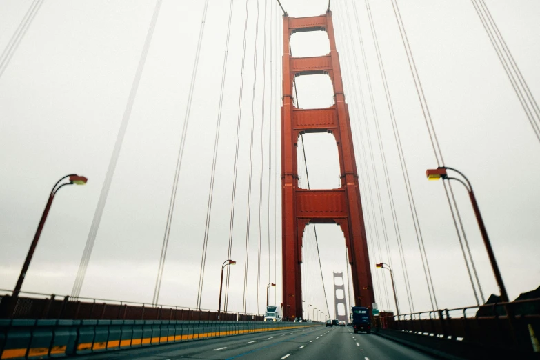 a view of the golden gate bridge from inside a car, unsplash, hurufiyya, fan favorite, tall structures, 1970s photo