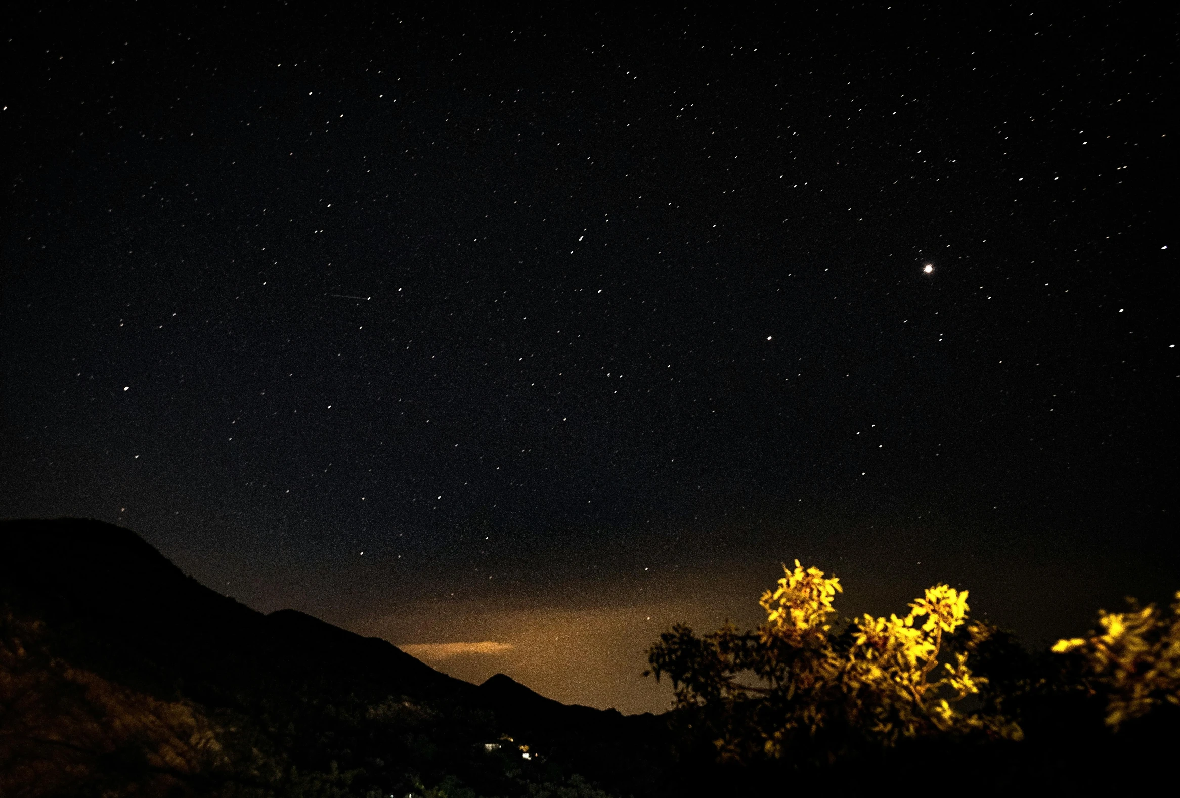 a night sky filled with lots of stars, a picture, unsplash, hurufiyya, moonless night, shot on sony a 7, distant mountains lights photo, golden orbs and fireflies