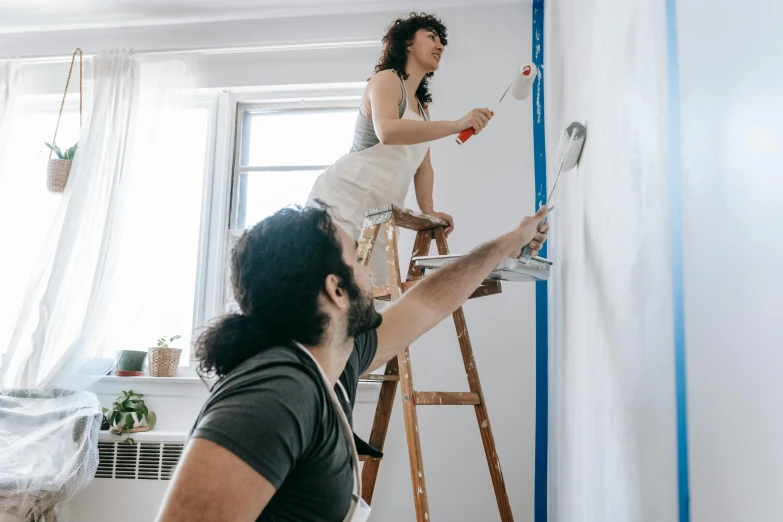 a man and a woman painting a wall, pexels contest winner, standing on a ladder, australian, as well as the handyboy, profile image