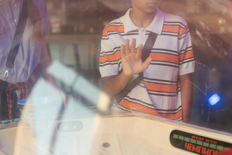 a man that is standing in front of a mirror, trending on unsplash, graffiti, bus stop, black teenage boy, waving hands, exiting store