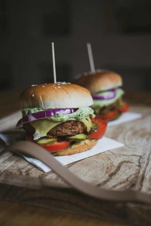 a couple of hamburgers sitting on top of a wooden table, by Sebastian Vrancx, pexels contest winner, crispy buns, instagram post, profile image, made of food