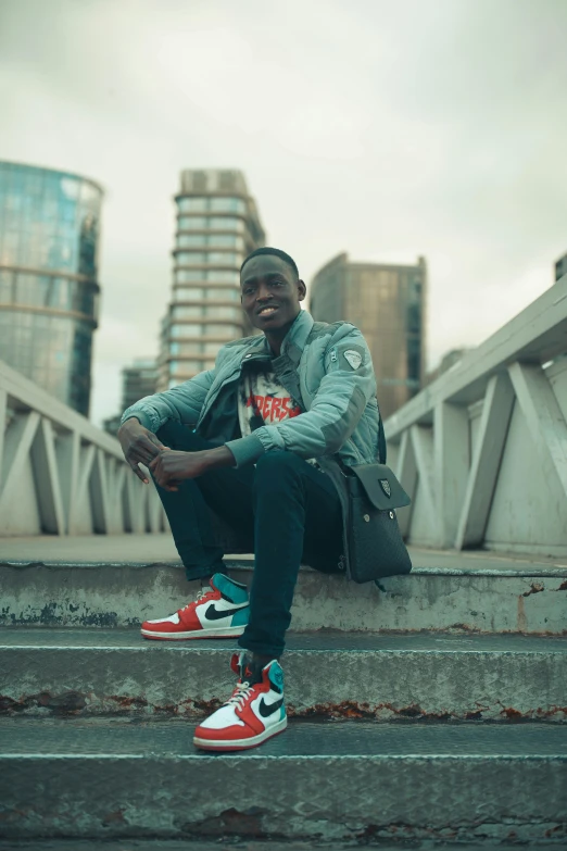 a man sitting on top of a set of stairs, an album cover, inspired by David Bailly, pexels contest winner, wearing nike air mags, godwin akpan, julian ope, headshot profile picture