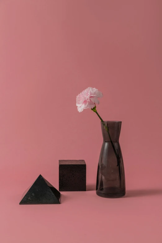 a vase that has a flower in it, a still life, inspired by Robert Mapplethorpe, unsplash, pink and black, square shapes, quartz, dark muted colors