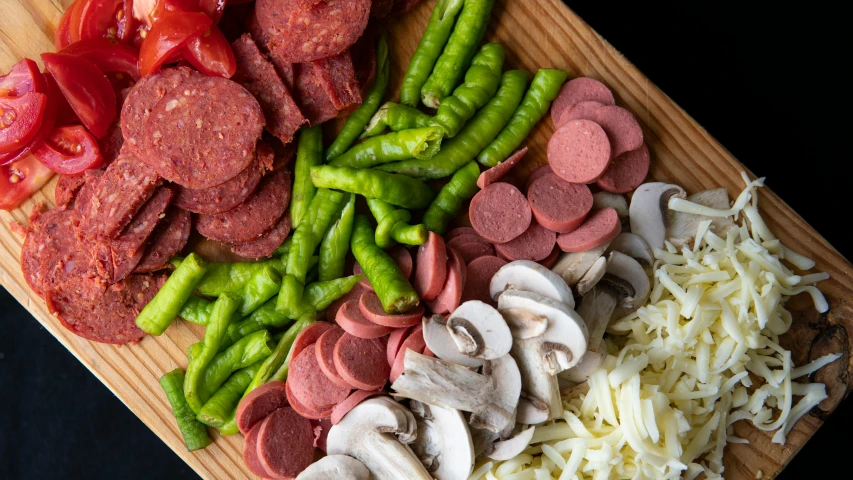 a cutting board with meat and vegetables on it, inspired by Géza Dósa, unsplash, cheese and pepperoni, wok, red and green, medium close-up