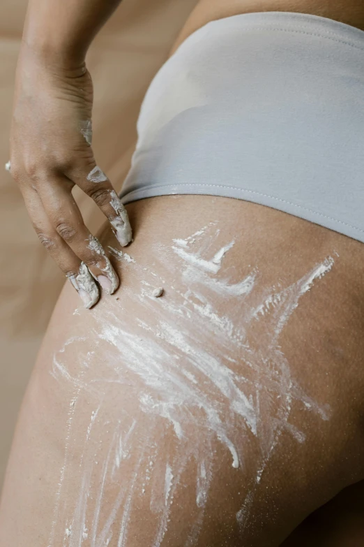 a close up of a person's butt with white paint on it, photoshoot for skincare brand, video still, full-body, candy treatments