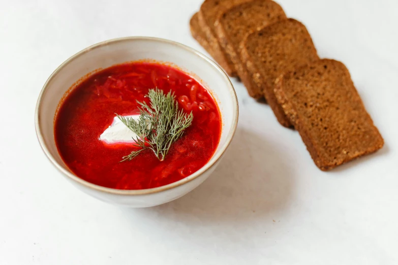 a bowl of soup and some bread on a table, by Emma Andijewska, pexels contest winner, plate of borscht, set against a white background, square, thumbnail