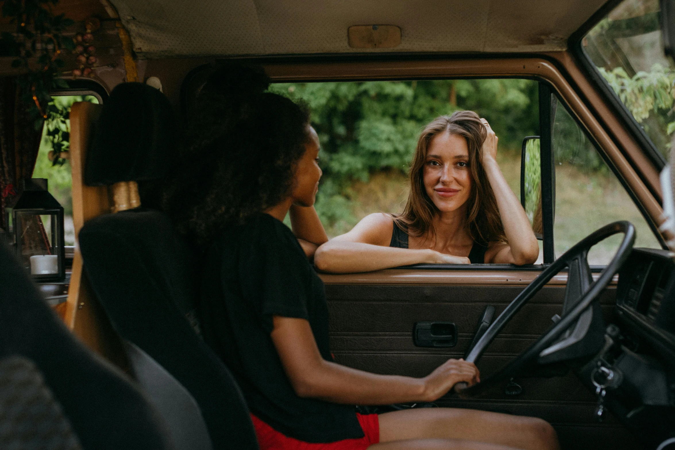 a woman sitting in the driver's seat of a van, pexels contest winner, happening, two girls, talking, avatar image, attractive photo