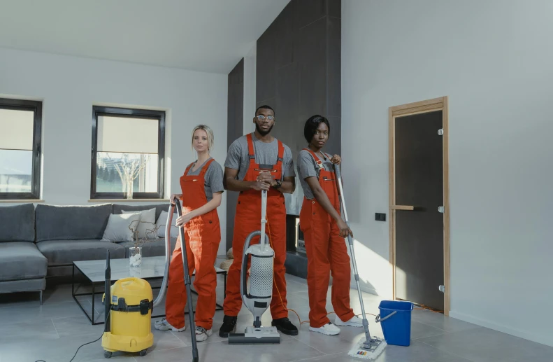 a couple of people that are standing in a room, vacuum, orange grey white, mkbhd, high quality photo