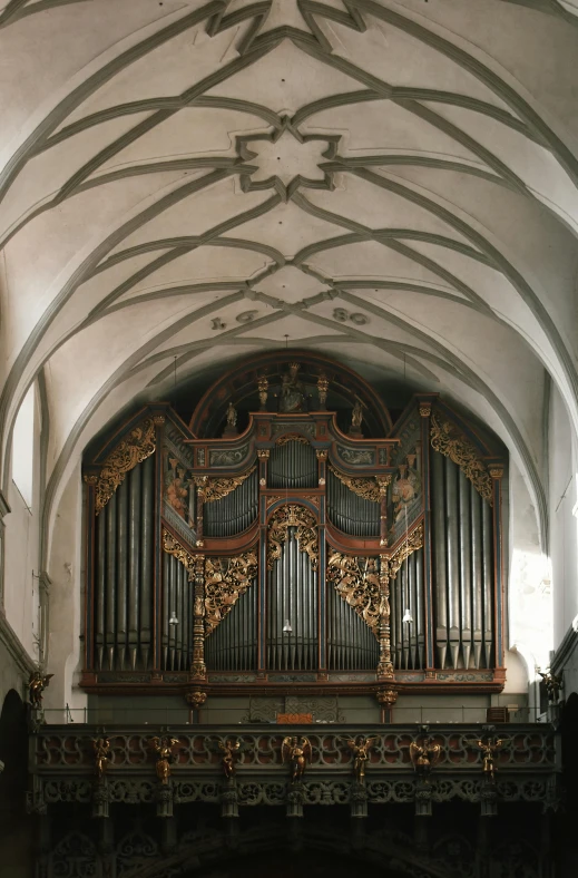 a large pipe organ sitting inside of a building, 1 5 th century, symmetrical front view, wooden ceiling, berkerk