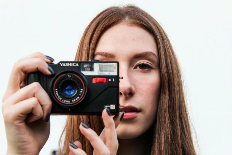 a woman taking a picture with a camera, a picture, inspired by Elsa Bleda, pexels contest winner, photorealism, hyperrealistic teen, rectangle, yashica t 4, centered face shot